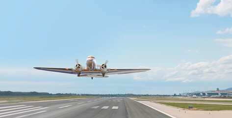 A propeller plane fly up over take-off runway from airport - Barcelona, Spain