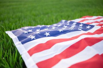 Close up of American flag on green grass. Concepts of national pride, patriotism and agriculture in...