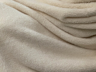 Soft fluffy fabric, white color, elegance of pleats