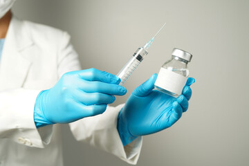 doctor or scientist holding a syringe with ampules vaccine, bottle for injection