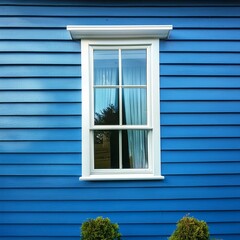 Fototapeta premium Blue vinyl siding texture and window, close-up view.