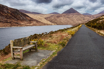 Silent Valley Reservoir Moure Mountains Lake wood bench on lakeshore Northern Ireland UK Europe