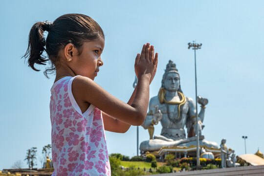 Child in Prayer at Sacred Statue murudeshwar