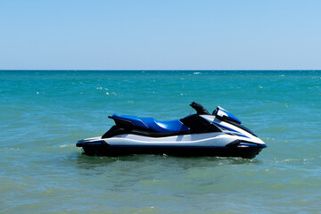 Blue sea and a jet ski floating on the sea. Water scooter is in the blue sea.