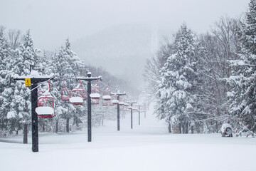 Ski mountain chairlift winter deep snow powder with snowy trees on a mountainside