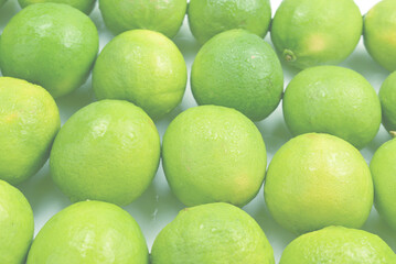 Many fresh limes on white background.
