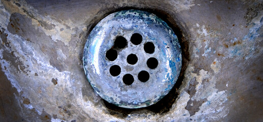 Old Weathered and Stained Drain in Sink