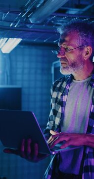 IT Server Technician Wearing Glasses Staring at Neon Display
