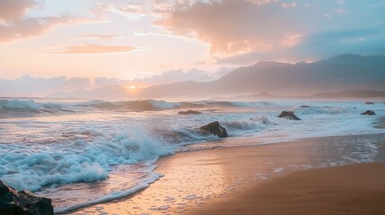 evening beach with waves, stones, and sunset glow