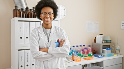 Confident woman scientist standing with arms crossed in a laboratory setting, exuding...