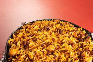 Baião de Dois traditional Brazilian food with rice, beans, sausage and rennet cheese close up