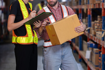 Warehouse workers inspect of products on warehouse shelves