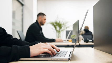 Diverse Multiethnic Group of Female and Male Students Sitting Together in Infographics Room, Collaborating on a College Project. Young Scholars Talking, Study Software Development or Computer Science