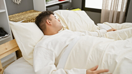 A young man sleeps peacefully in a cozy bedroom, evoking comfort and relaxation.