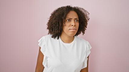 African american woman with curly hair against pink background