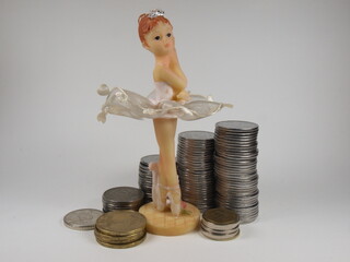 Subject photography. figurine of a ballerina. Dancer. Money, coins, business. For decoration and design