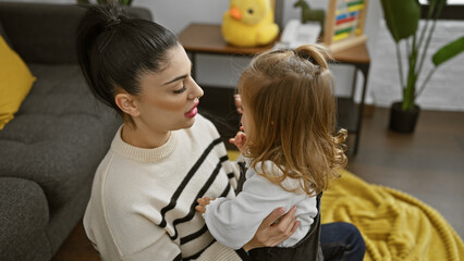 A mother and daughter share a tender moment in a cozy living room, embodying family love and togetherness.