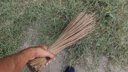 broom in hand, old tree skewer photo cleaning