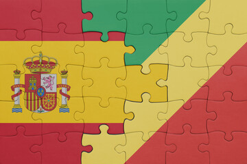 puzzle with the colourful national flag of republic of the congo and flag of spain.