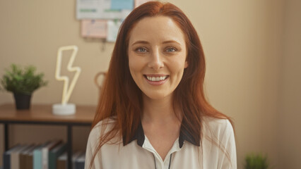 Smiling redhead woman in casual attire standing in a modern home office