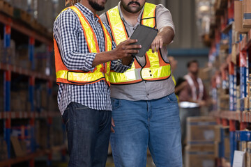 Warehouse workers inspect of products on warehouse shelves
