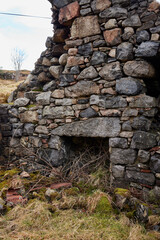 Interior stone hearth in a derelict cottage in Argyll and Bute, Scotland, UK