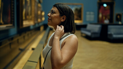 Young beautiful hispanic woman visiting art gallery at Art Museum in Vienna