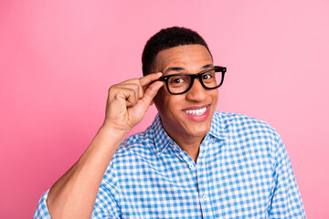Photo of attractive funny guy wear plaid shirt arm spectacles emtpy space isolated pink color...