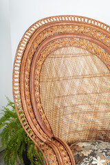 Intricate woven rattan chair. Vintage furniture. Interior product photograph.