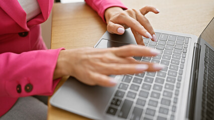 Industrious woman business worker, typing, working with laptop in elegant office interior