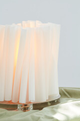 White sculptural papercraft lamp. Mid-century modern decor. Close-up photograph.