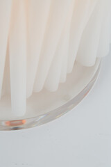 White sculptural papercraft lamp. Mid-century modern decor. Close-up photograph.