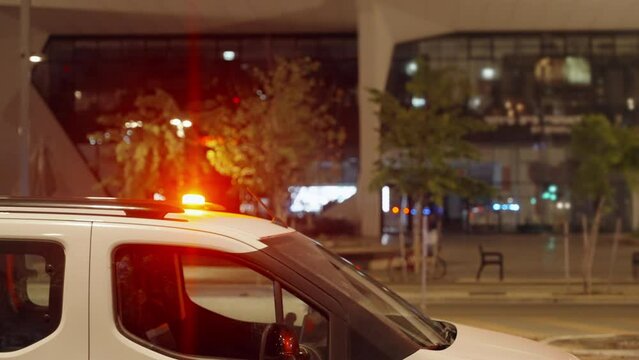Police patrol vehicle or car with siren lights flashing red and blue outside in urban city street in crime scene or demonstration in public event