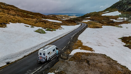 Campervan or motorhome travel camper van, Caravan trailer, or camper RV at the Lyse road covered with snow to Krejag Norway Lysebotn, road covered with snow 