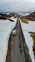 Campervan or motorhome travel camper van, Caravan trailer, or camper RV at the Lyse road covered with snow to Krejag Norway Lysebotn, road covered with snow in Spring in the mountains