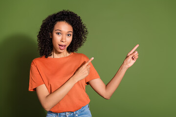 Photo portrait of lovely young lady point amazed empty space dressed stylish orange garment isolated on khaki color background