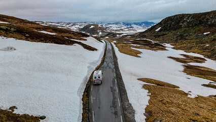 travel camper van, Caravan trailer, or camper RV at the Lyse road covered with snow to Krejag Norway Lysebotn, a road covered with snow in Spring