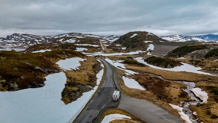 Campervan or motorhome travel camper van, Caravan trailer, or camper RV at the Lyse road covered with snow to Krejag Norway Lysebotn, road covered with snow in Spring