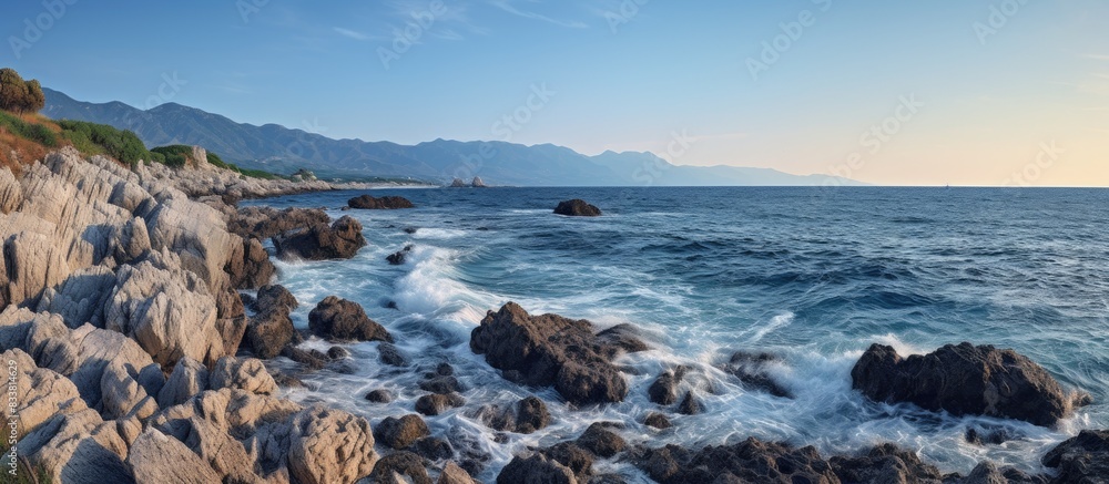 Poster adriatic coast with sea waves crashing against rocky shore with copy space image.