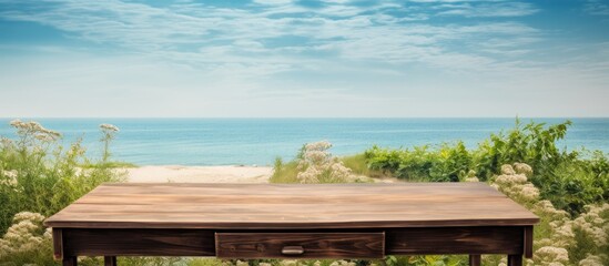 Obraz premium Wooden desk with ample copy space image for personal decor alongside a summer beach landscape.