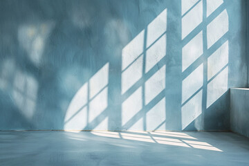 Fototapeta premium Soft shadows and highlights from windows on a light blue plaster wall, minimal product background
