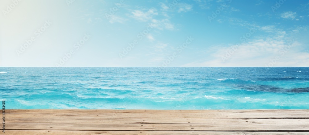 Poster product placement on a blue wooden board with a shimmering sea in the background, creating a summer 