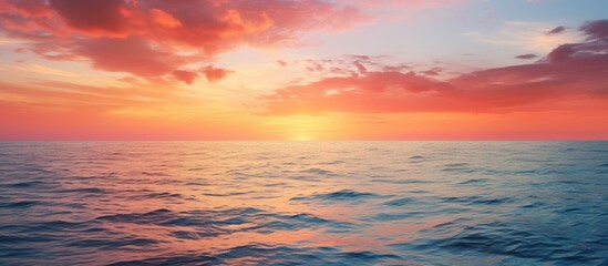 Fototapeta premium Vivid sunset over the tranquil sea, offering ample copy space image.
