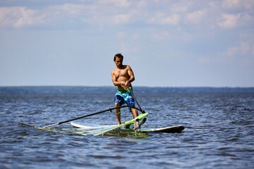 Windsurfer raise the sail of a sailboard