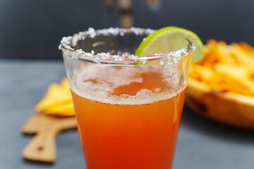 Mexican cocktail, michelada, made with beer and tomato juice. Selective focus