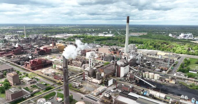Drone shot of smokestack with smoke coming out at Krefeld Uerdingen chemical park in Germany