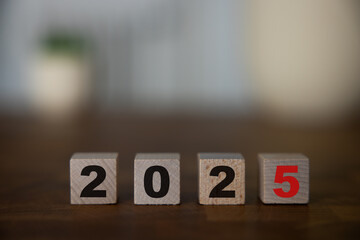 Wooden block with numbers 2025 on wooden table with white background, New Year 2025 