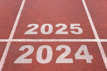 Rear view of a athlete preparing to start on an athletics track engraved with the year 2025, business strategy concept.