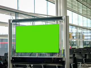 Airport Terminal: Green Screen Advertising Billboard, Arrival Display with Chroma Key, Mock-up AD Space. Backgrond: Diverse Crowd of People Wait for their Flights in Boarding Lounge of Airline Hub