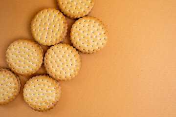 Sandwich cookies, chocolate cream filled biscuit stuck on brown yellow background. Modern cookies concept.
